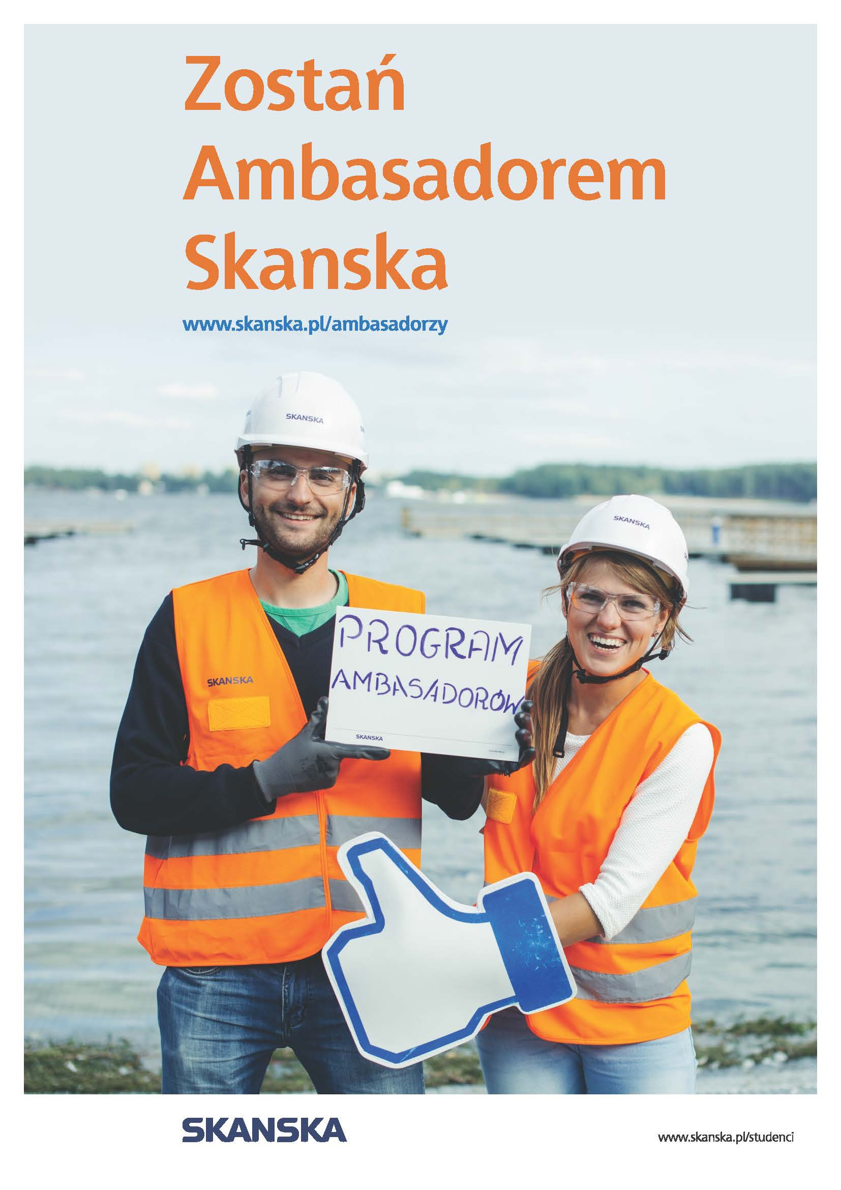 Dwóch pracowników Skanska w kamizelkach odblaskowych trzyma tabliczkę z napisem "PROGRAM AMBASADORÓW" i symbol kciuka w górę.