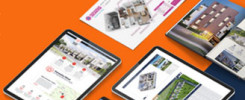Na pomarańczowym tle leżą tablet, smartfon i broszury z wizualizacjami nieruchomości. Widoczne są plany mieszkań i budynków.